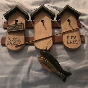 Wall art with fish and birdhouses.